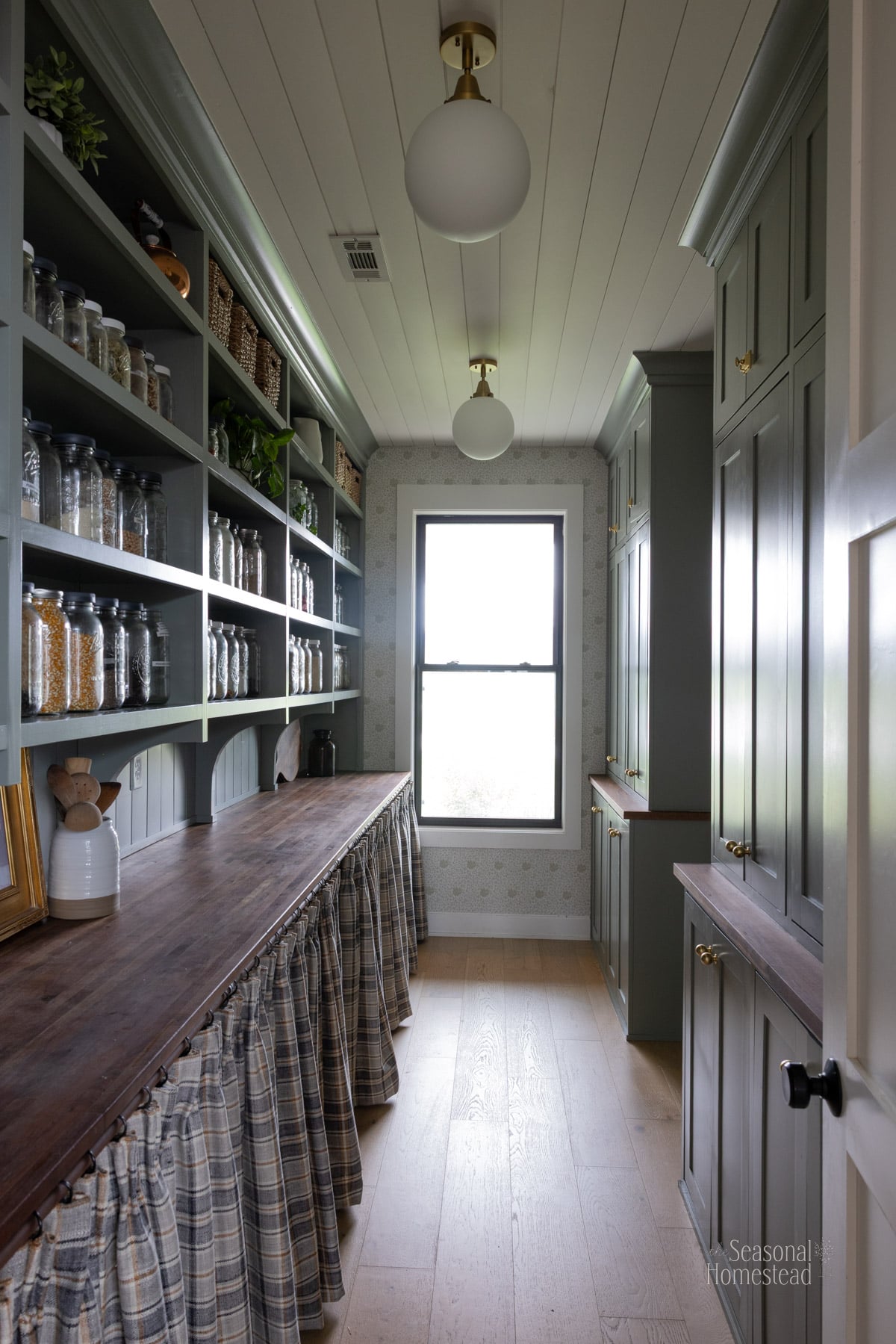 Rustic teaching kitchen with wooden countertops, herbs, and warm natural tones